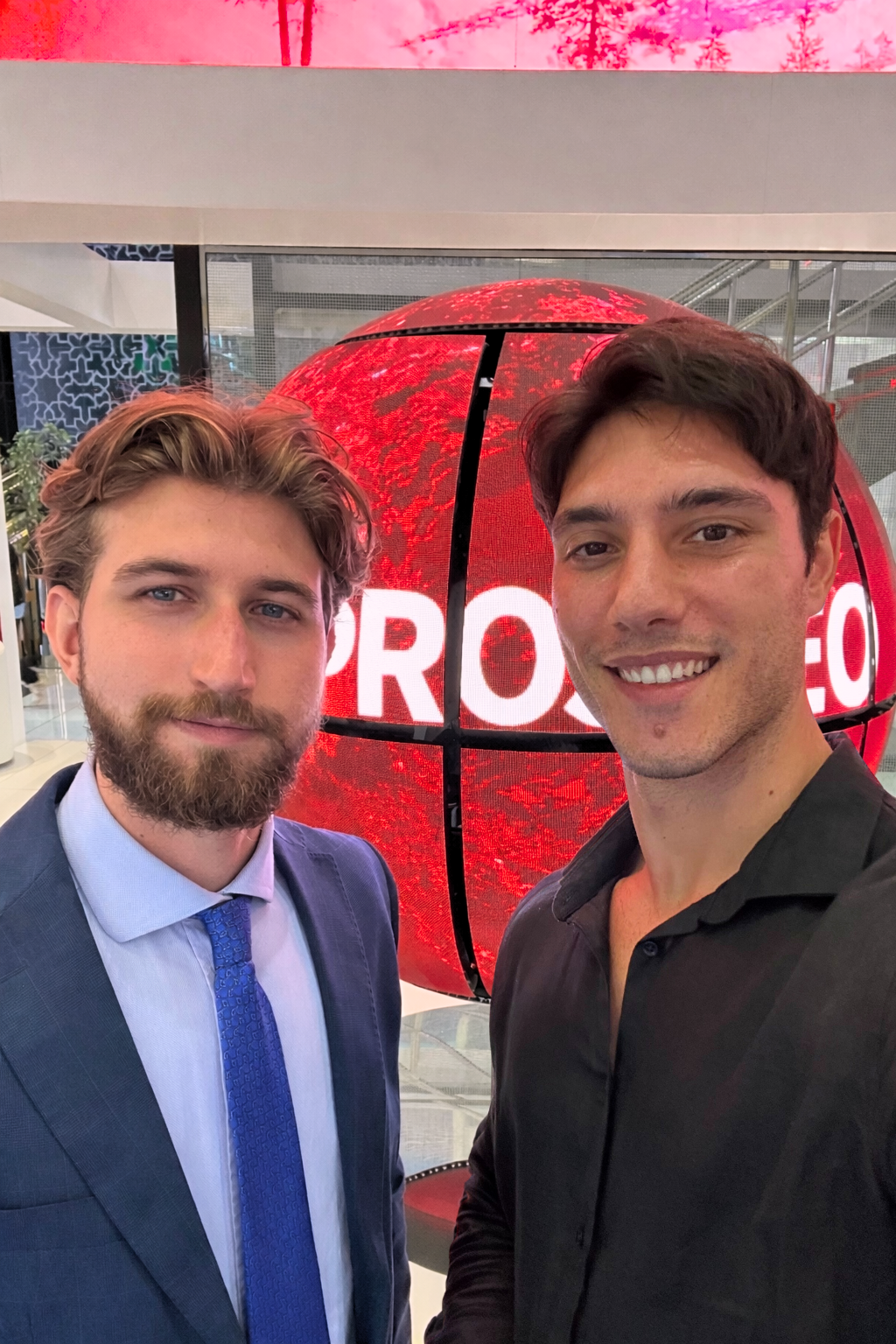 Growth Cab and Prospeo team members in front of the Prospeo sphere display